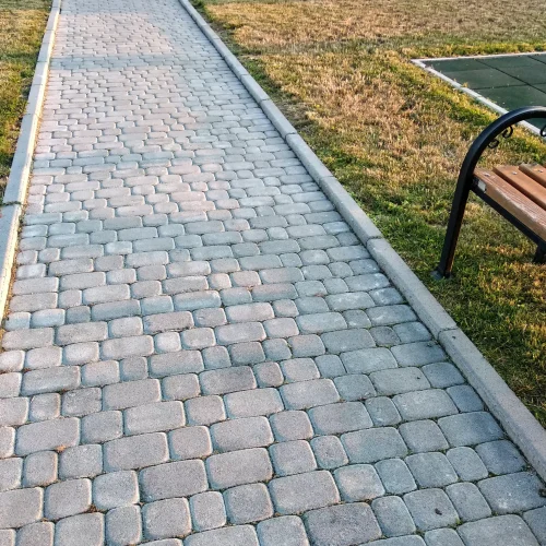 close-up-of-slab-stone-paved-path-way-at-park-or-b-2026-01-06-09-53-35-utc